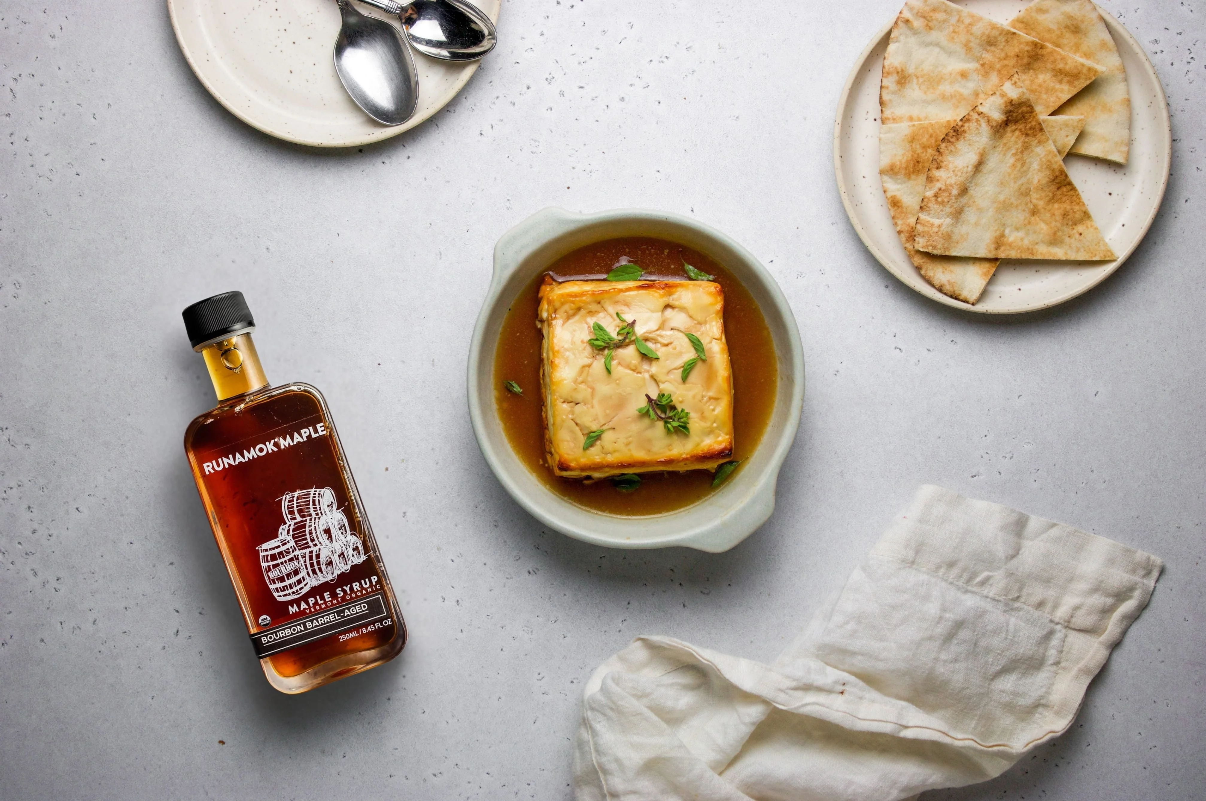Baked feta with tomatoes and bourbon maple, made with Bourbon Barrel-Aged Maple Syrup from Runamok